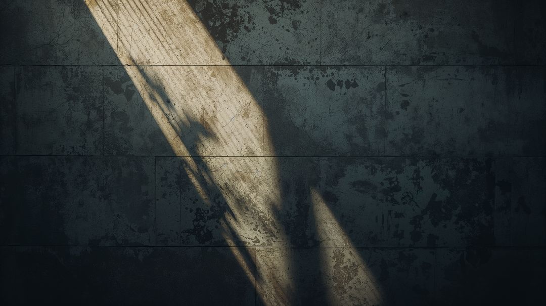 Diagonal Sunlight Beam Casting Dramatic Light Across Weathered Concrete Panel Wall Texture