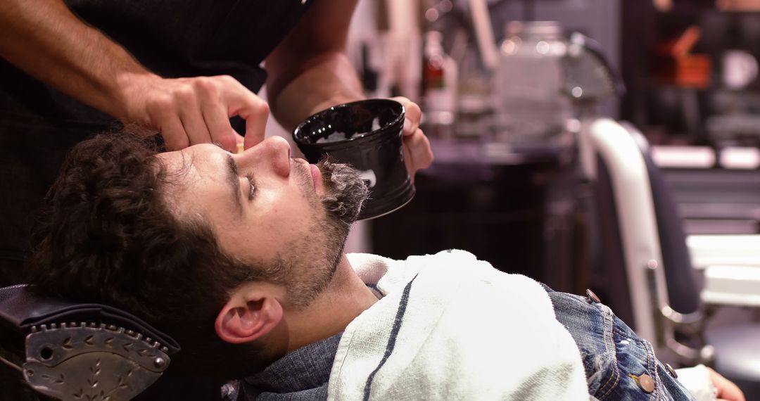 Barber Applying Lather to Man's Beard with Brush in Barber Shop - Free Images, Stock Photos and Pictures on Pikwizard.com