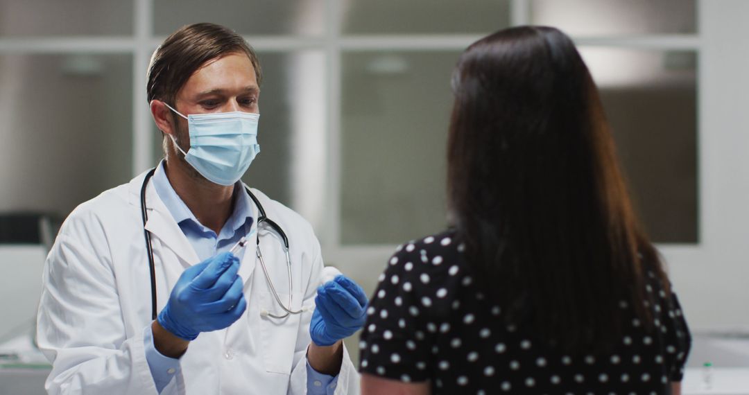 Caucasian male doctor wearing face mask giving vaccination to a female patient - Free Images, Stock Photos and Pictures on Pikwizard.com