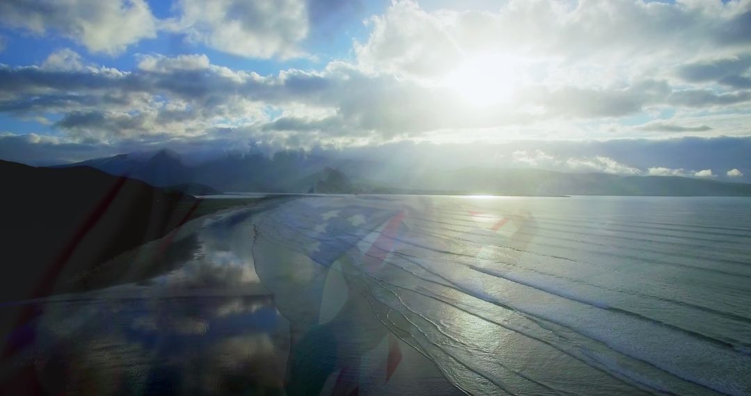 Serene Coastal Sunset with American Flag Overlaid on Ethereal Skies