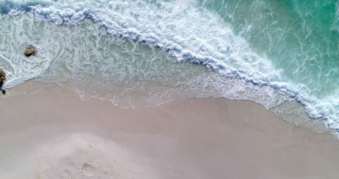 Aerial View of Serene Waves on Sandy Beach - Free Images, Stock Photos and Pictures on Pikwizard.com