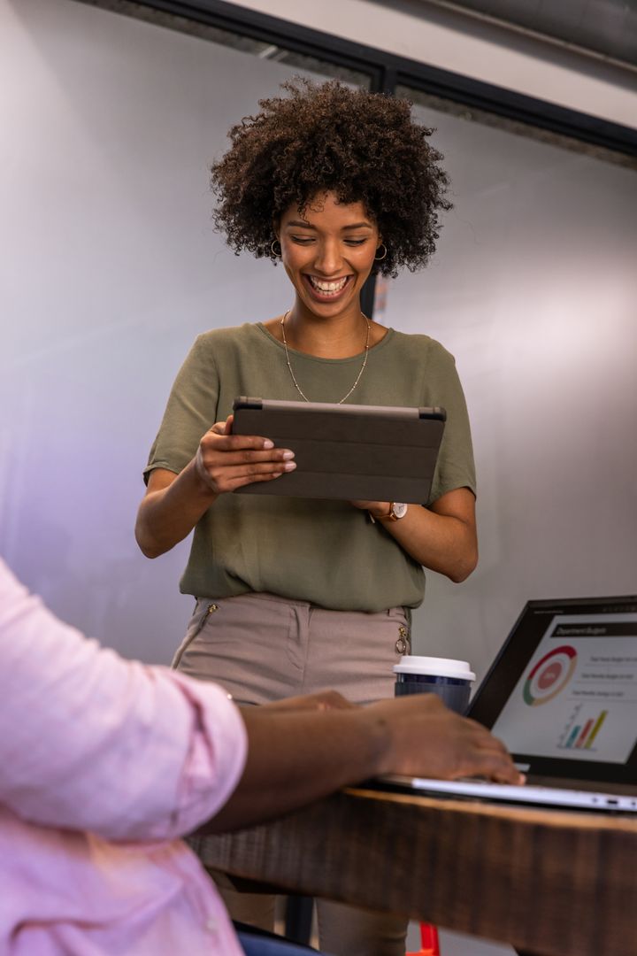 Collaborative Team Meeting With Laptops and Digital Devices in Modern Office