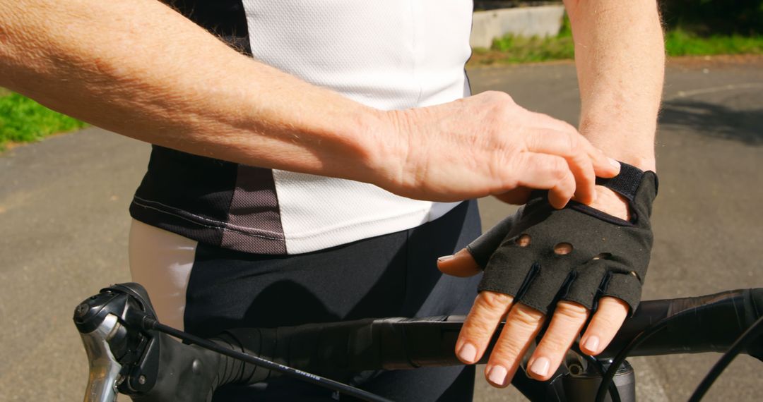 Cyclist Adjusting Padded Gloves on Road Bike - Free Images, Stock Photos and Pictures on Pikwizard.com