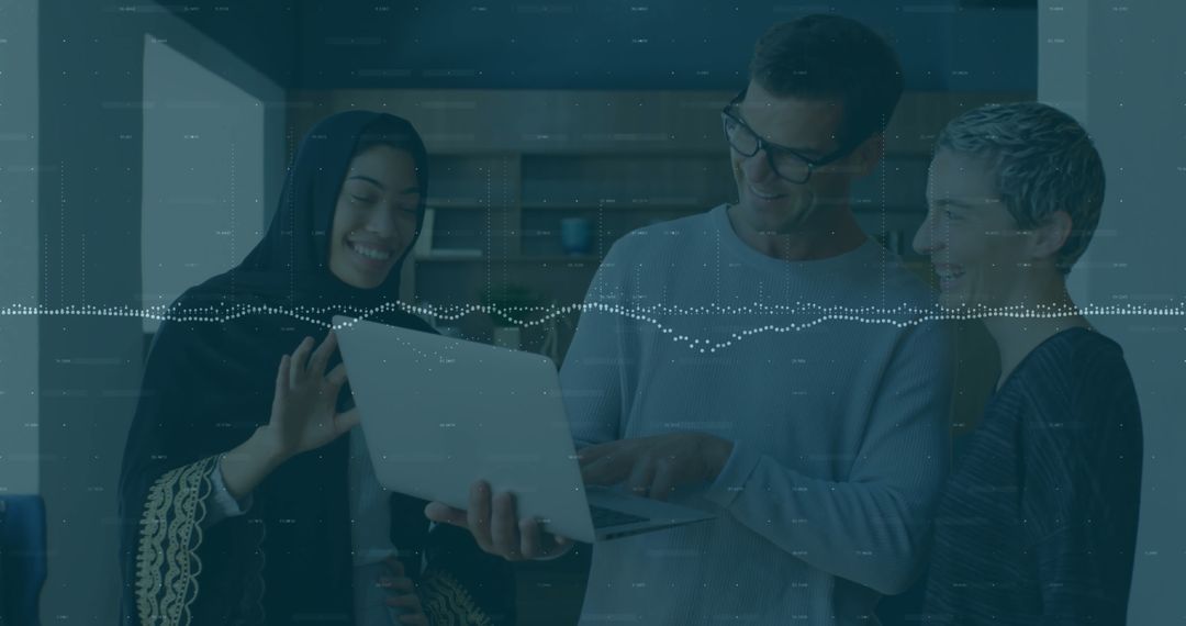 Diverse Professionals Collaborating with Laptop in Modern Workspace