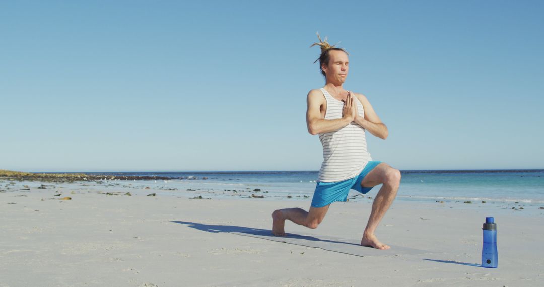 Man Practicing Yoga on Beach in Sunny Weather - Free Images, Stock Photos and Pictures on Pikwizard.com