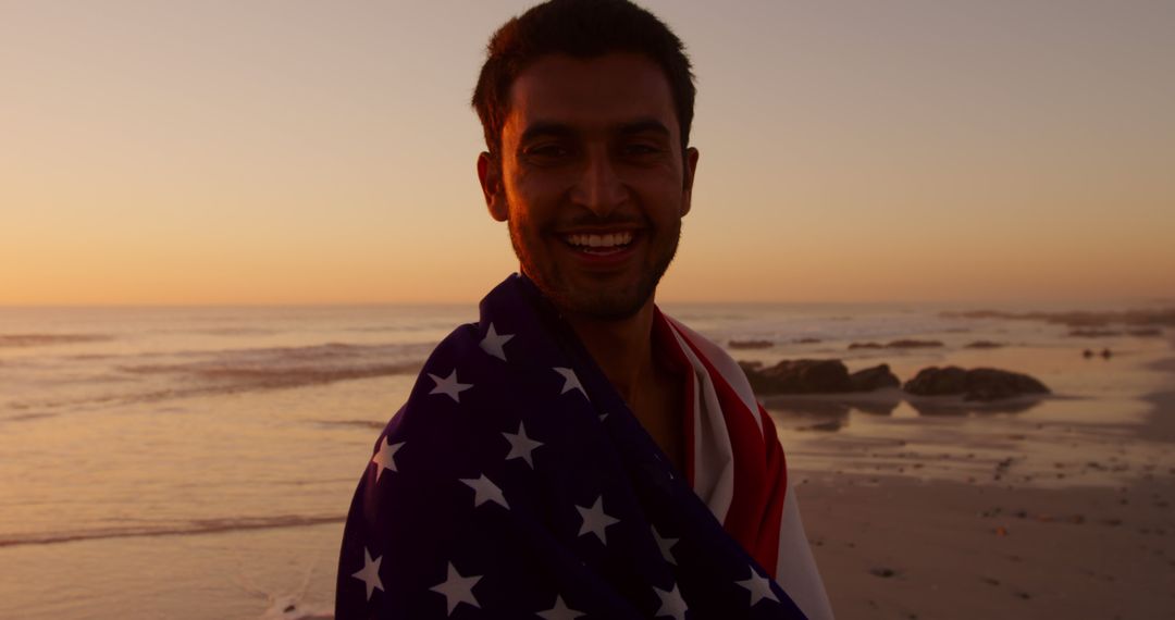 Smiling Man with American Flag at Beach during Sunset - Free Images, Stock Photos and Pictures on Pikwizard.com