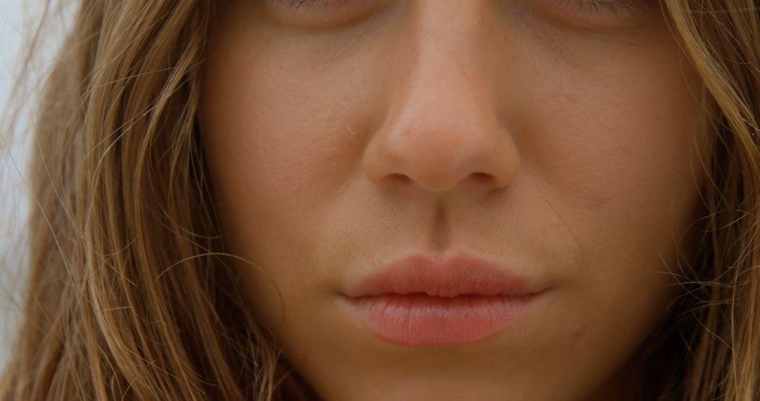 Close-Up of Caucasian Woman's Face with Subtle Smile at Beach