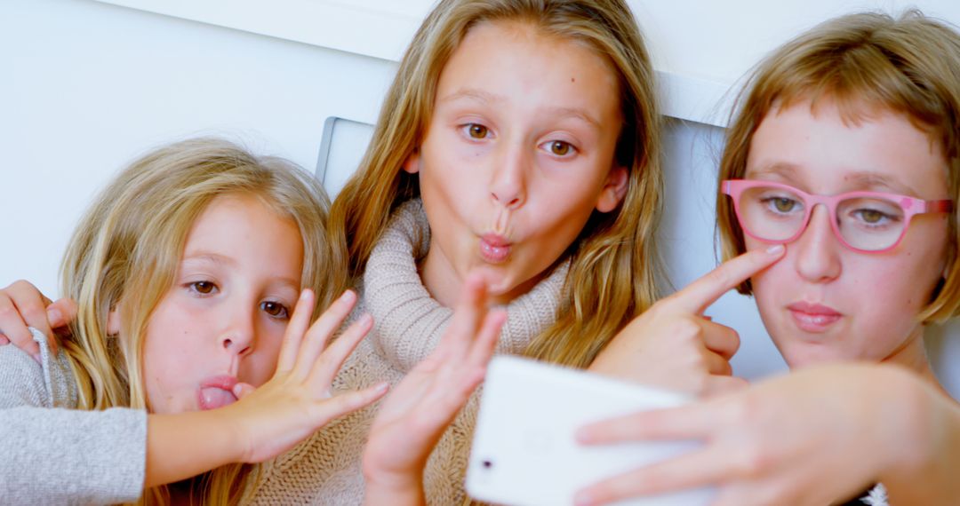 Three girls making funny faces while taking selfie at home - Free Images, Stock Photos and Pictures on Pikwizard.com