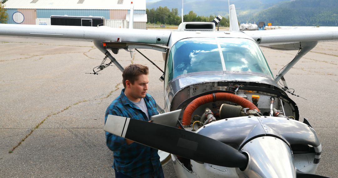 Mechanic Inspecting Hangar-Centered Small Aircraft - Free Images, Stock Photos and Pictures on Pikwizard.com