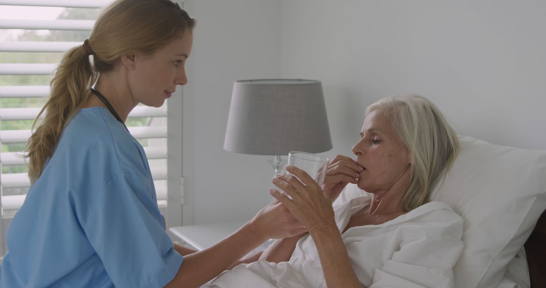 Nurse Caring for Elderly Woman in Bedside Assistance - Free Images, Stock Photos and Pictures on Pikwizard.com