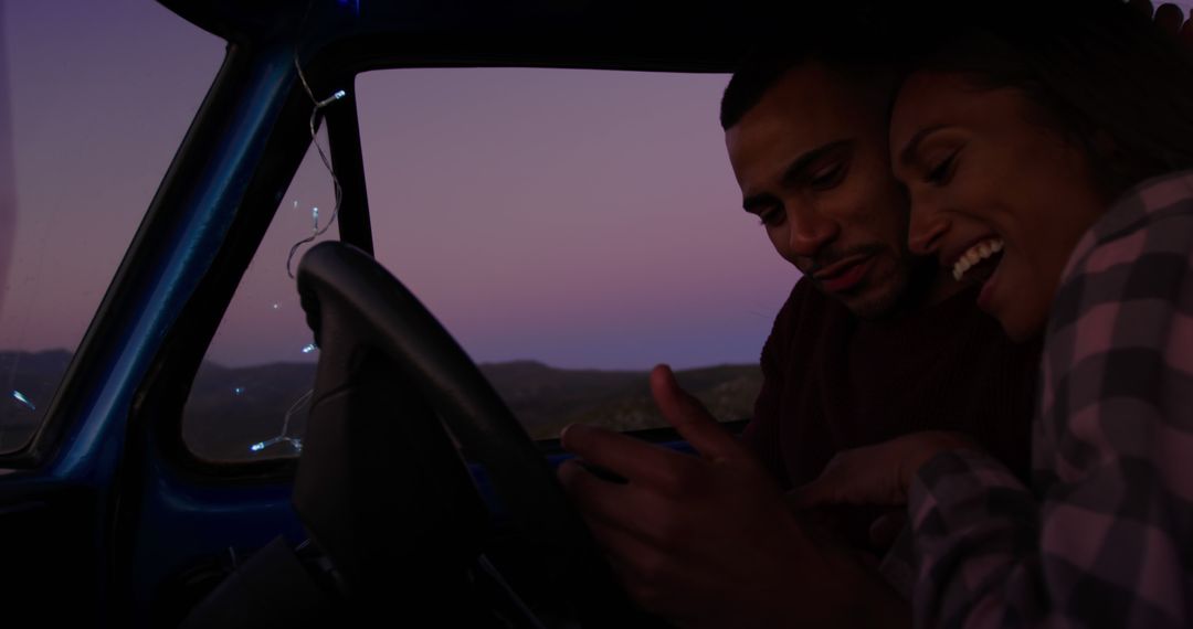 Couple enjoying digital map on road trip at sunset - Free Images, Stock Photos and Pictures on Pikwizard.com