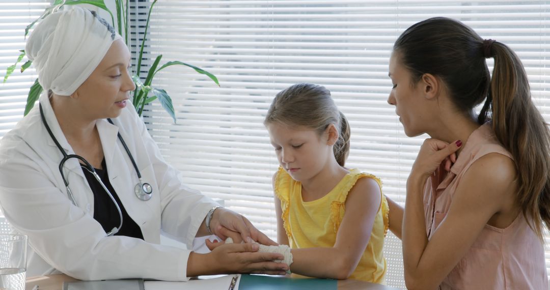 Female Doctor Examining Young Girl's Broken Arm in Clinic - Free Images, Stock Photos and Pictures on Pikwizard.com