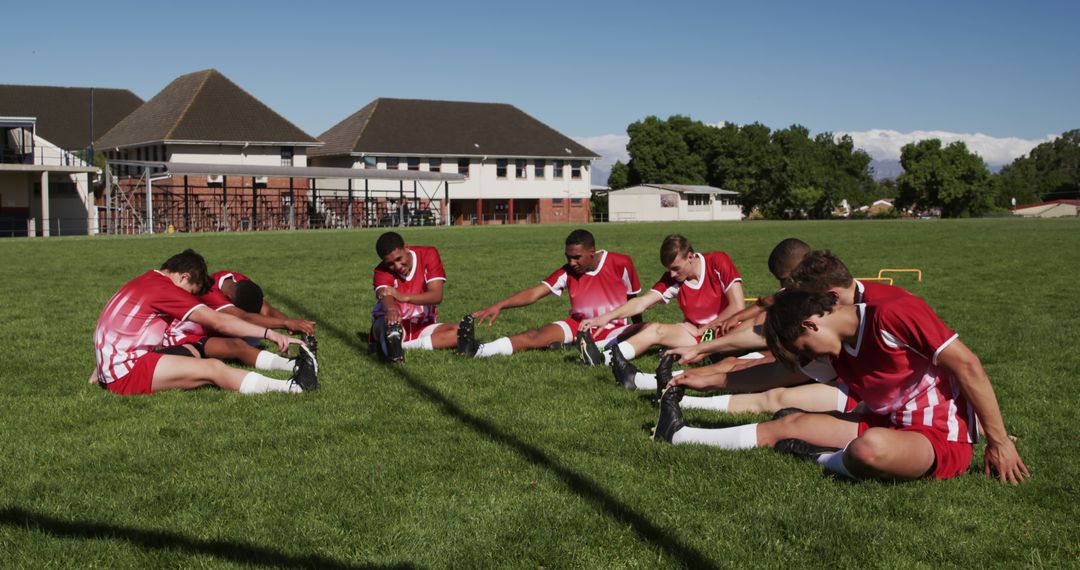 Youth Soccer Team Stretching on Grass Field before Training Session - Free Images, Stock Photos and Pictures on Pikwizard.com