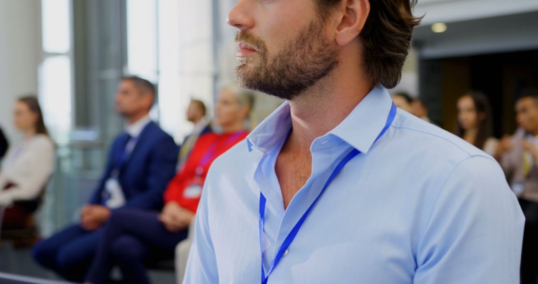 Focused Businessman at Seminar with Colleagues Background