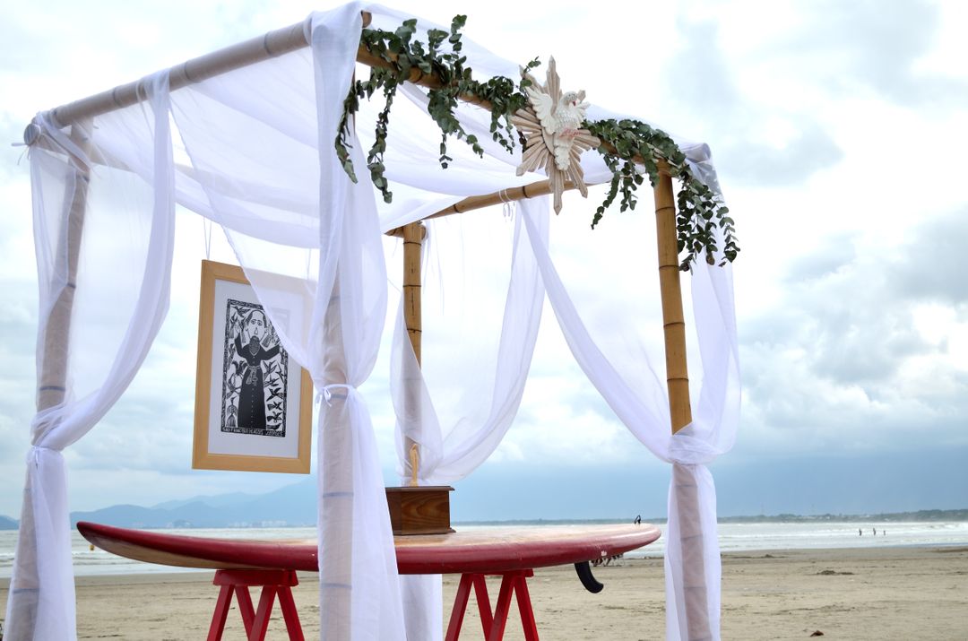 Beach Wedding Altar with Surfboard and White Drapes on a Cloudy Day - Free Images, Stock Photos and Pictures on Pikwizard.com