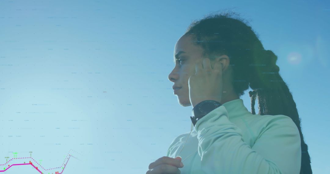 Woman jogging on seaside with digital statistics overlay