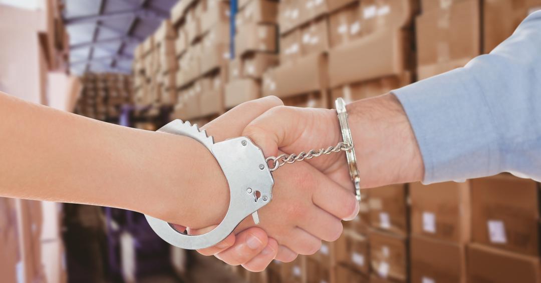 Business People in Handcuffs Shaking Hands in Warehouse - Free Images, Stock Photos and Pictures on Pikwizard.com