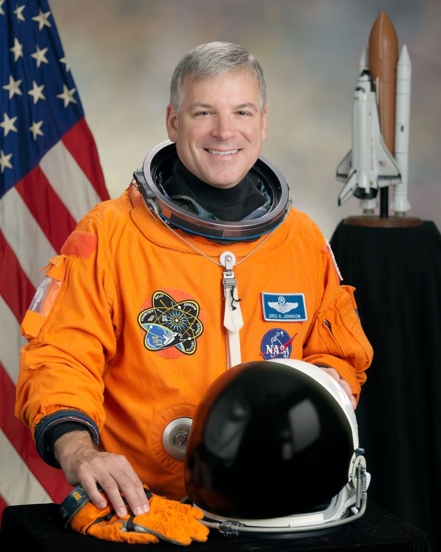 NASA Astronaut Gregory H. Johnson Posing in Orange Spacesuit