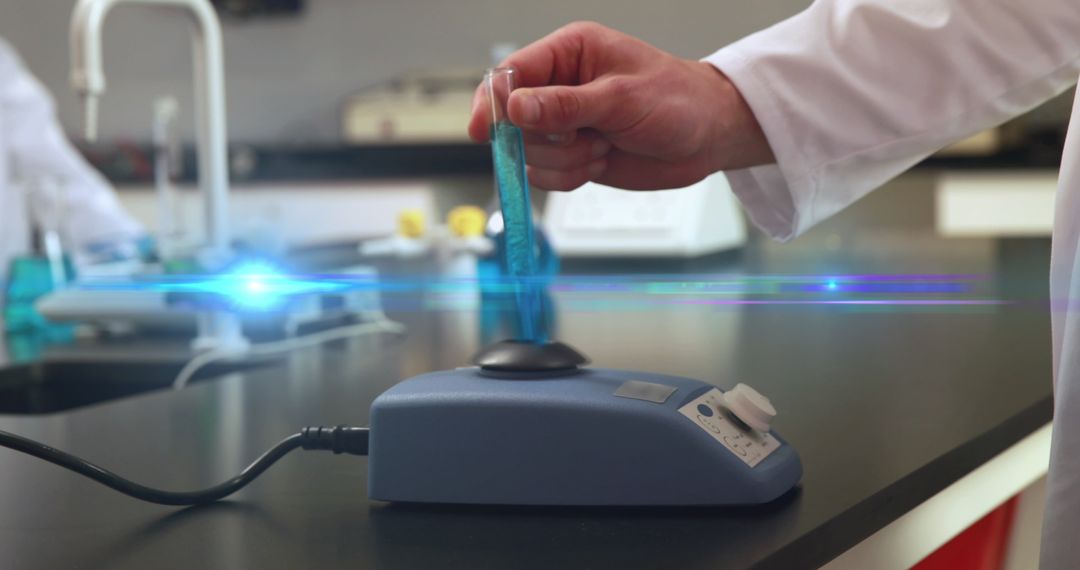 Hand Mixing Chemical in Laboratory Test Tube Shimmering Effects