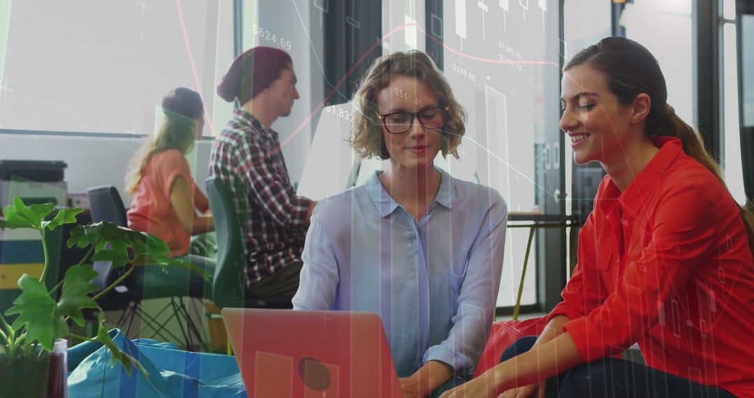 Collaborative Team Analyzing Financial Data on Laptop