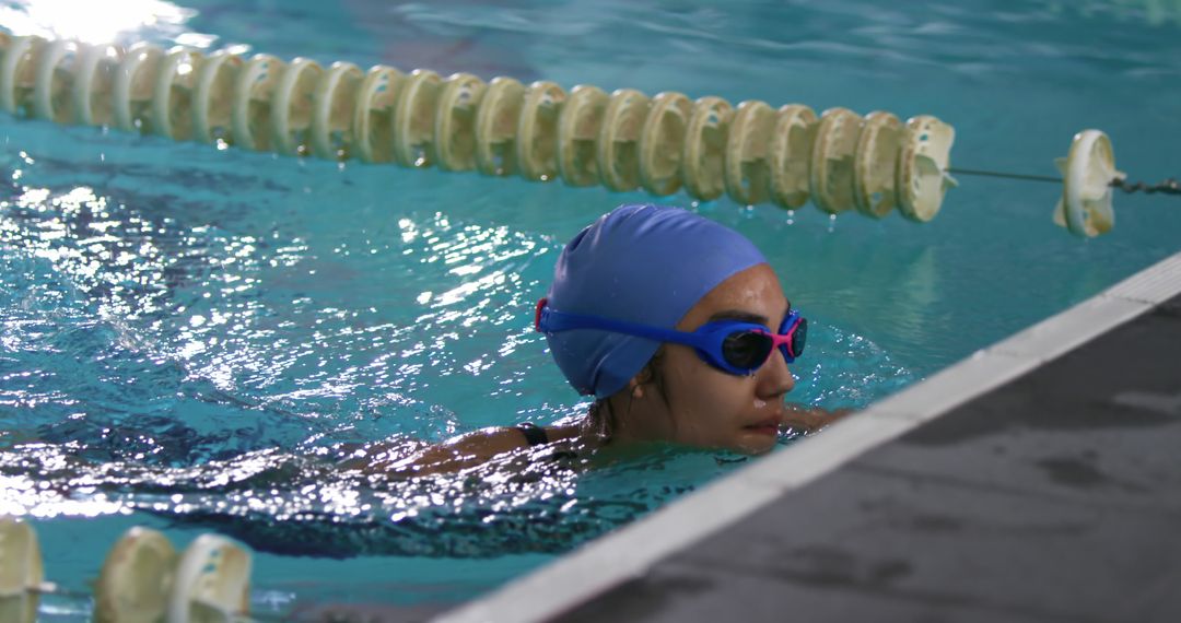 Woman Taking Rest During Intensive Swim Practice Indoors