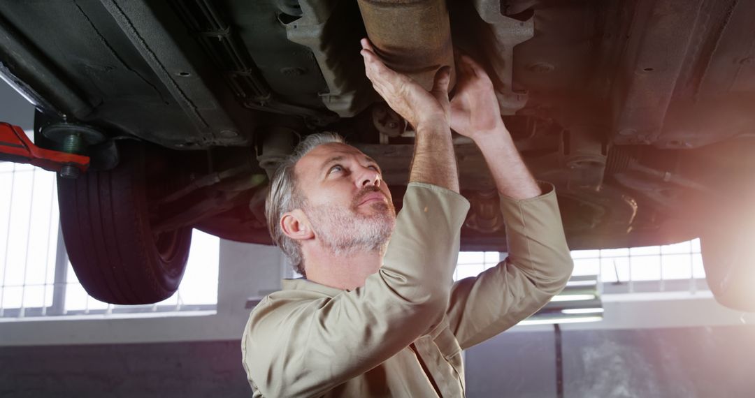 Senior Mechanic Inspecting Car Exhaust System - Free Images, Stock Photos and Pictures on Pikwizard.com