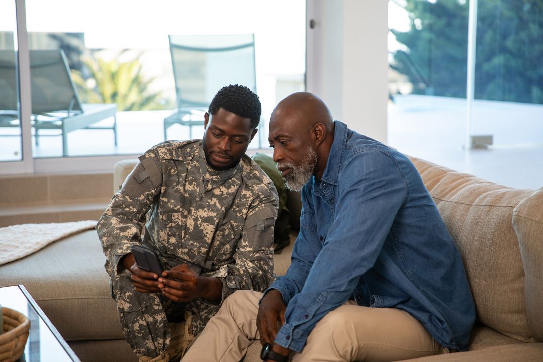 African American Father and Son Engaging with Technology at Home