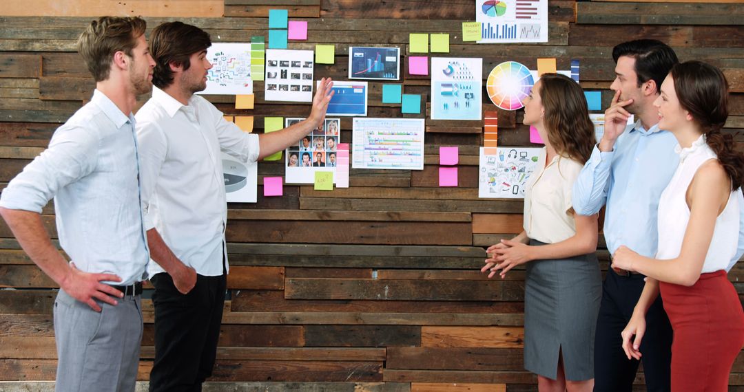 Business Team Collaborating on Creative Strategy with Sticky Notes and Charts