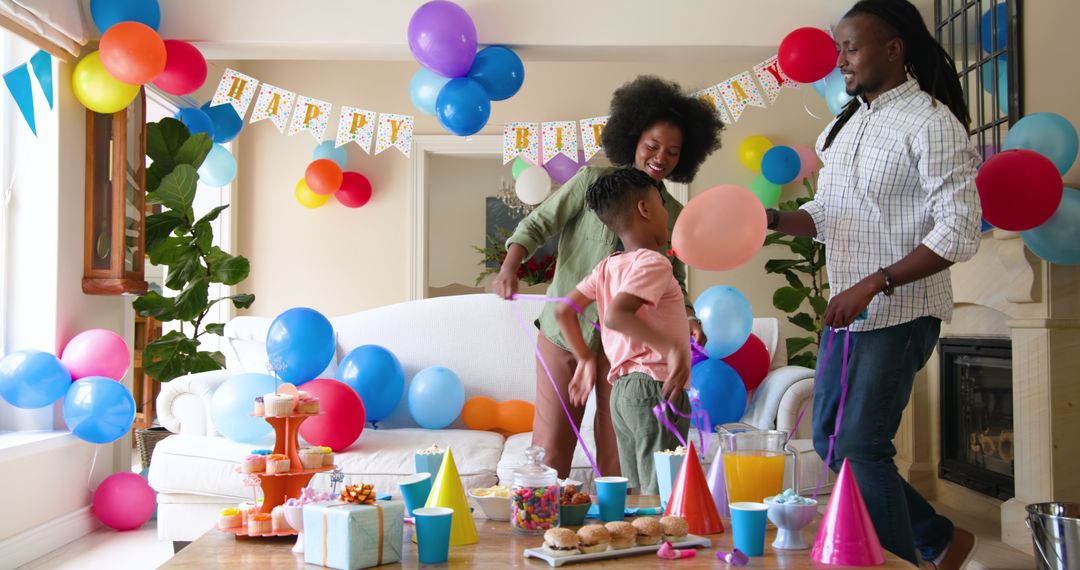 Family Decorating Room for Child's Birthday Party Celebration