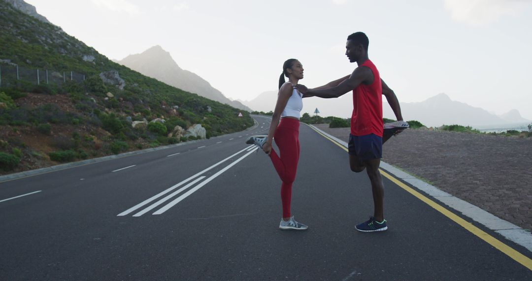 Young Couple Stretching on Scenic Road Before Workout - Free Images, Stock Photos and Pictures on Pikwizard.com