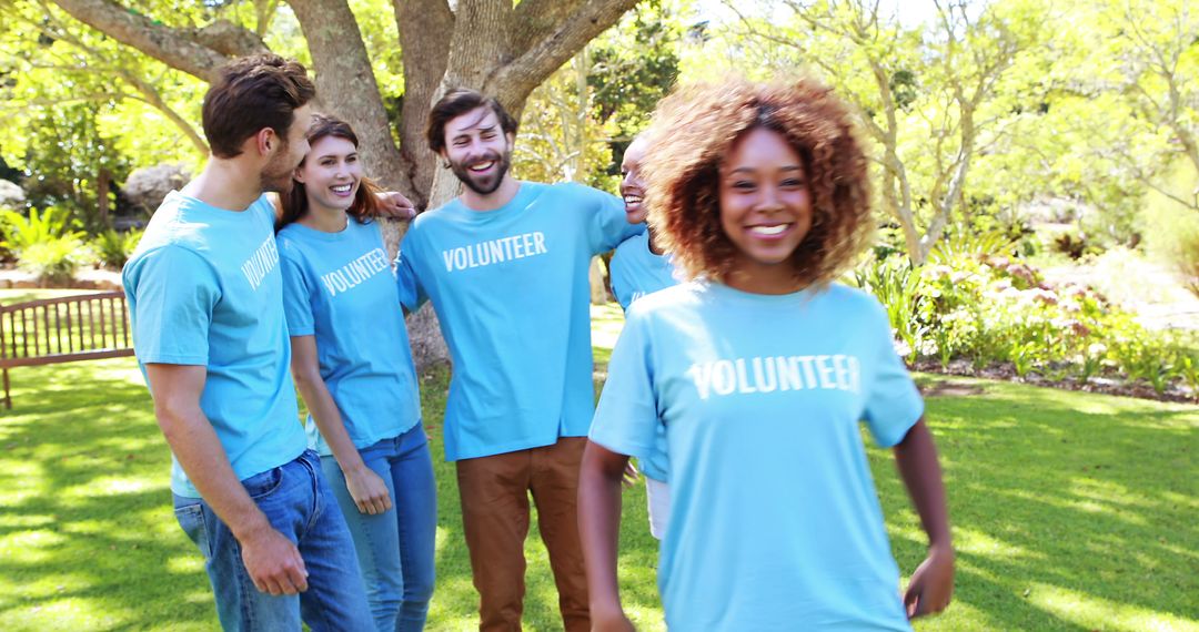 Diverse Group of Volunteers in Blue T-Shirts Enjoying Outdoor Event - Free Images, Stock Photos and Pictures on Pikwizard.com