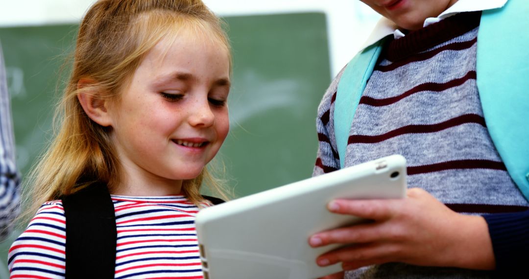 Young Students Smiling and Learning with Tablet in Classroom - Free Images, Stock Photos and Pictures on Pikwizard.com