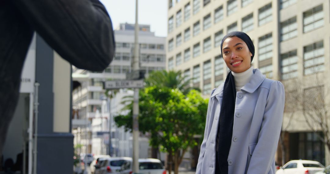 Confident Woman in Hijab Smiling Outdoors in Urban Setting - Free Images, Stock Photos and Pictures on Pikwizard.com