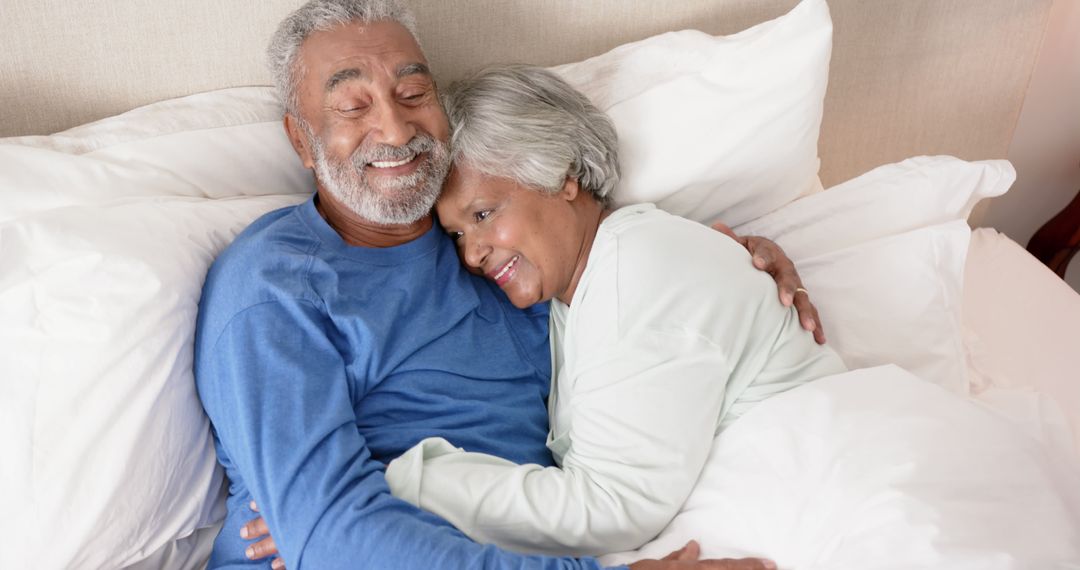 Senior Couple Smiling and Embracing in Bed - Free Images, Stock Photos and Pictures on Pikwizard.com