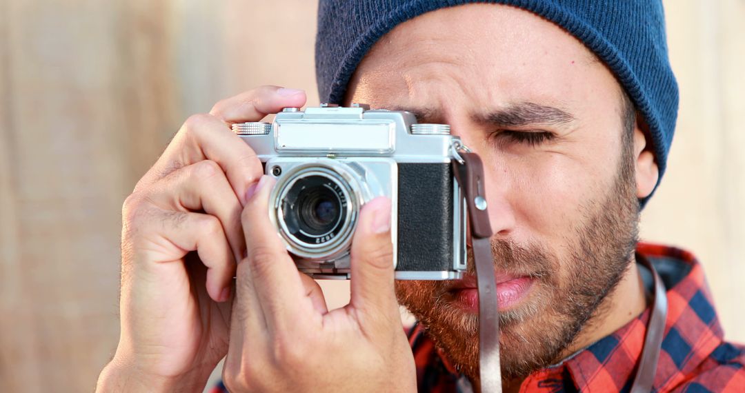 Young Bearded Photographer Focusing with Vintage Camera - Free Images, Stock Photos and Pictures on Pikwizard.com