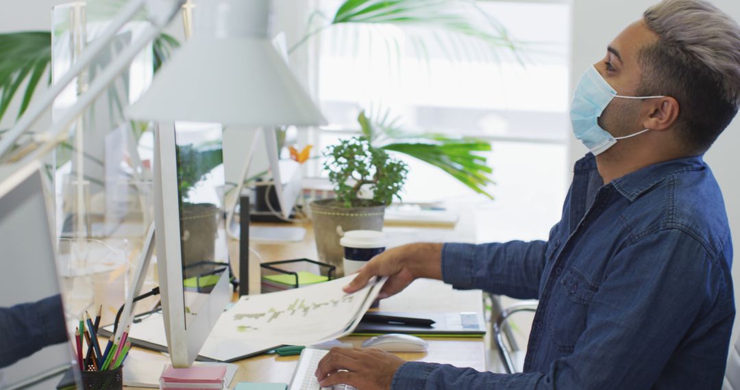 Professional in Mask Working Alone at Office Desk, Bright Workspace