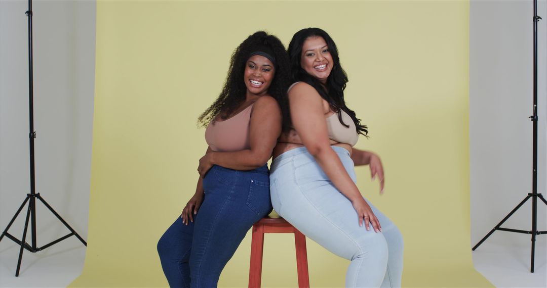 Confident Diverse Models Posing Back-to-Back in Fashion Studio