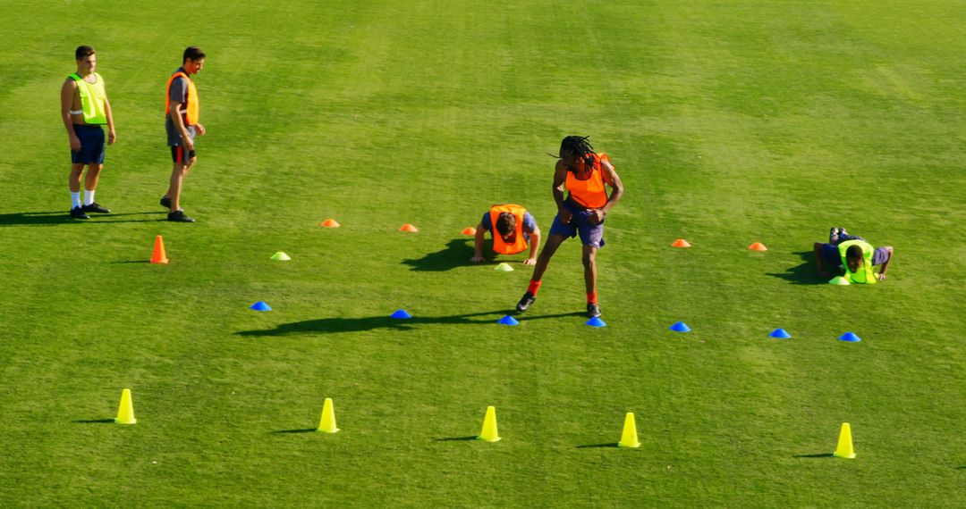 Athletes Training on Grass Field with Cones - Free Images, Stock Photos and Pictures on Pikwizard.com