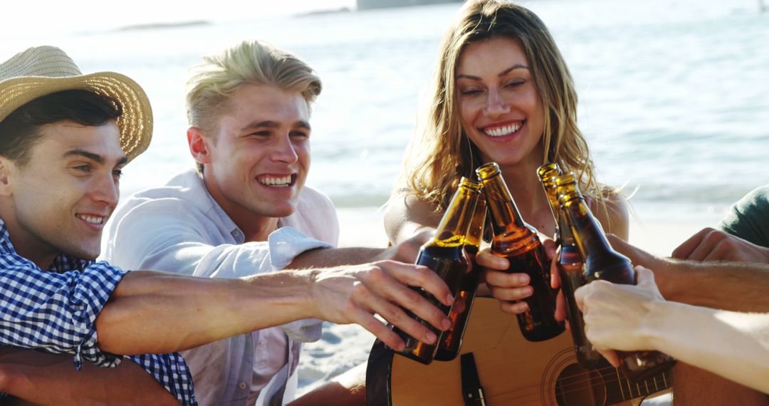 Friends toasting with beer bottles on beach - Free Images, Stock Photos and Pictures on Pikwizard.com