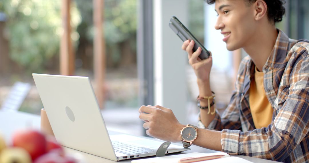 Young Entrepreneur Communicating with Smartphone in Modern Workspace