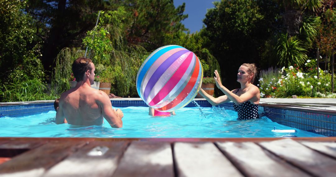 Family Enjoying Fun Pool Time with Beach Ball on Sunny Day - Free Images, Stock Photos and Pictures on Pikwizard.com