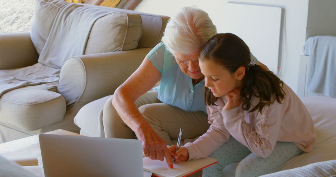 Grandmother Helping Granddaughter with Homework on Couch - Free Images, Stock Photos and Pictures on Pikwizard.com