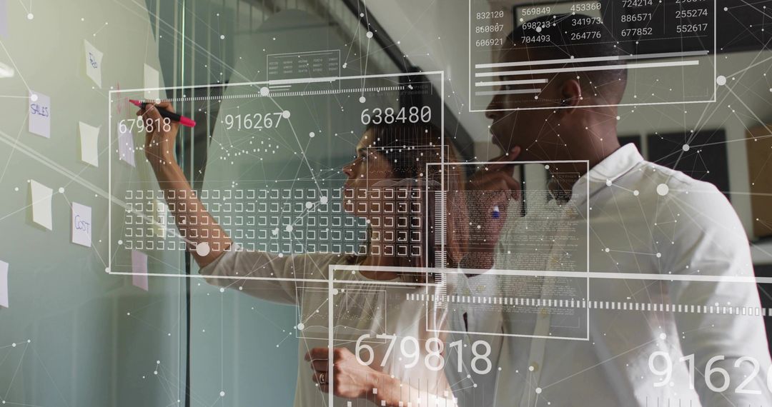 Business Professionals Analyzing Data on Glass Wall with Digital Overlays