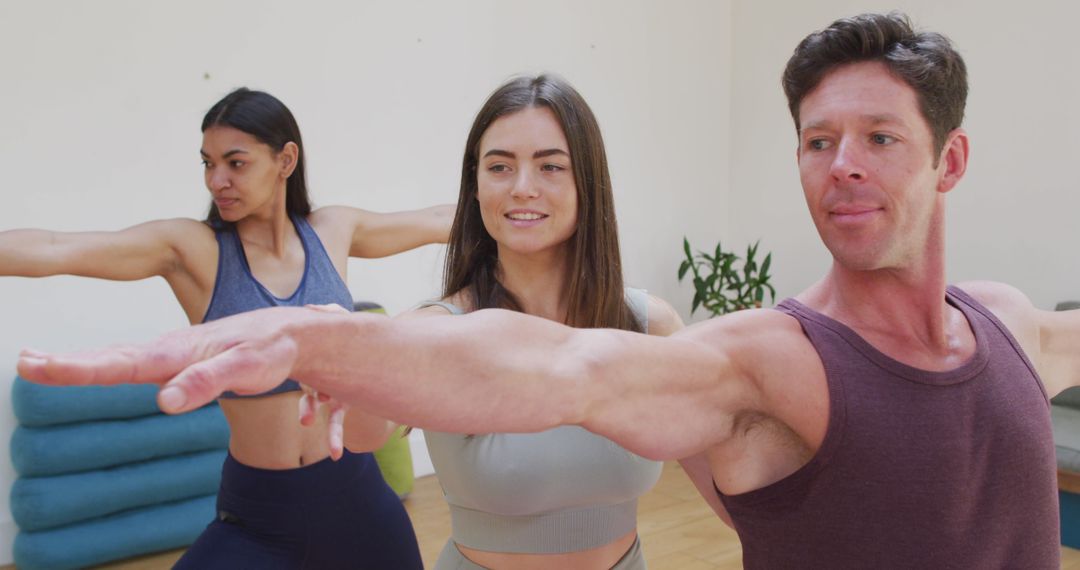 Diverse Group Practicing Yoga with Female Instructor