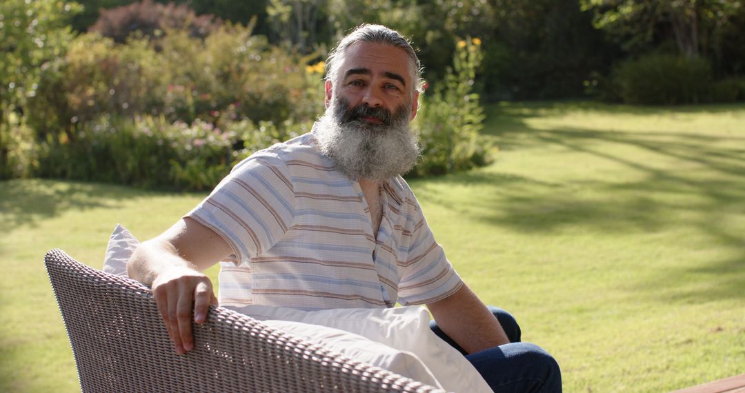 Senior Man Relaxing on Chair in Sunny Garden Atmosphere