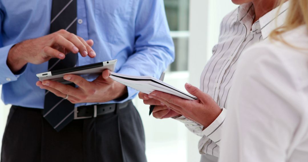 Business Professionals Collaborating with Tablet and Notebook