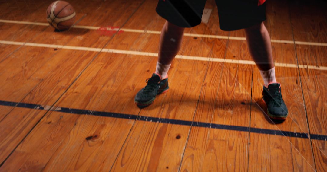Athlete Preparing for Basketball Action in Gymnasium