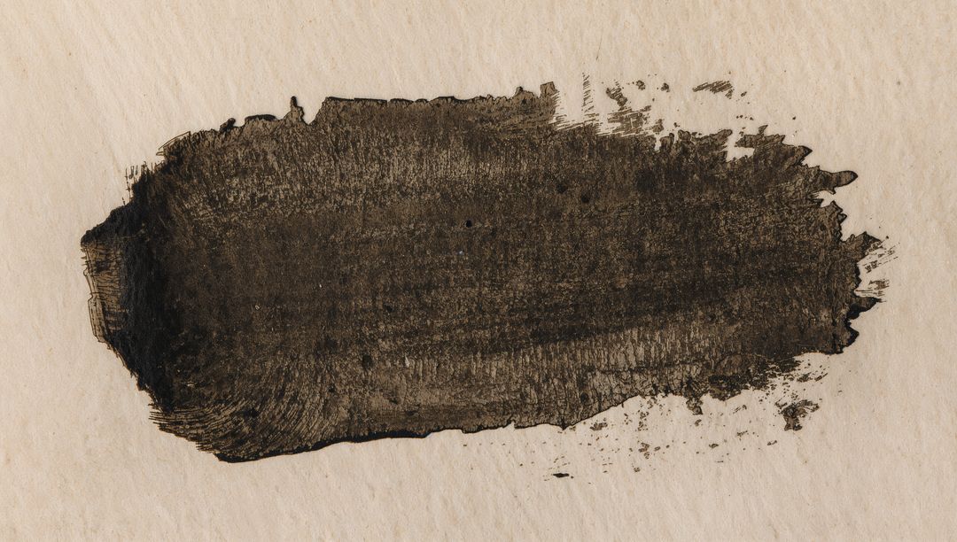 Wide Dark Ink Brushstroke on Cream Paper with Bristle Marks, Splatters and Paper Grain Texture