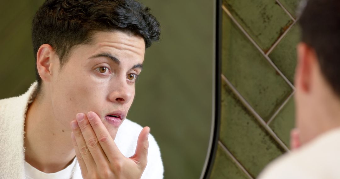 Man Examining Face in Bathroom Mirror for Skin Care Routine