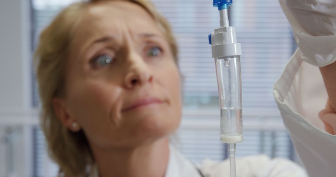 Female Doctor Observing Intravenous Doubtful On Liquid Level - Free Images, Stock Photos and Pictures on Pikwizard.com